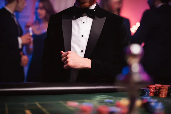 A young woman relaxing with her phone while dynamic casino elements float around her, illustrating the smooth mobile experience offered by the KK333 app.