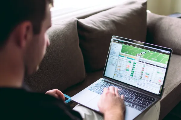 A cheerful woman in traditional clothing using her smartphone during a festive moment, showing how easily the KK333 app fits into everyday life.