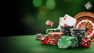 KK333 Casino Games — Enjoy nonstop entertainment A close-up shot of golden coins falling around a spinning roulette wheel, representing immersive casino action at KK333.